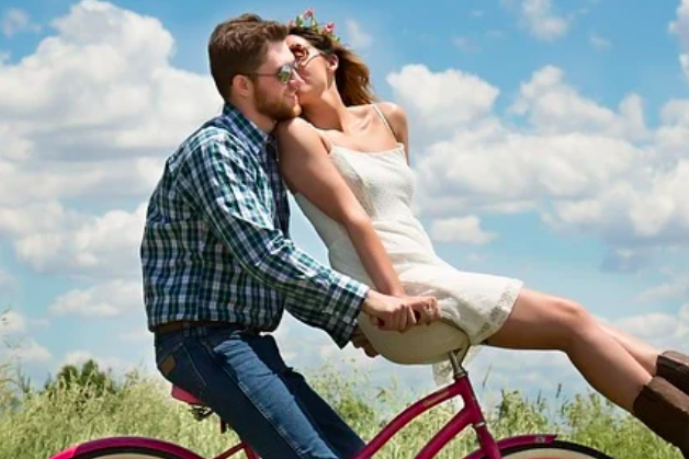 Couple on bike kissing