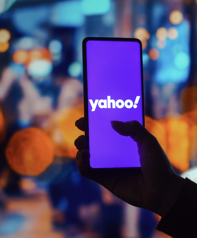 Yahoo on mobile phone in hand